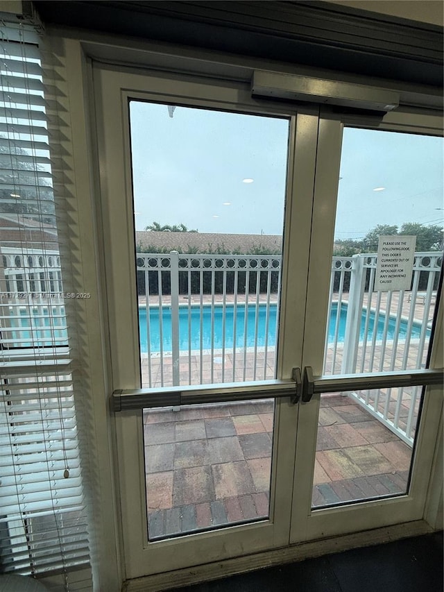 entryway featuring plenty of natural light, a water view, and a beach view