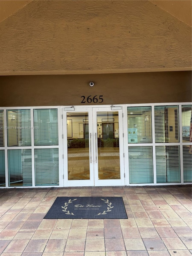 view of exterior entry featuring french doors