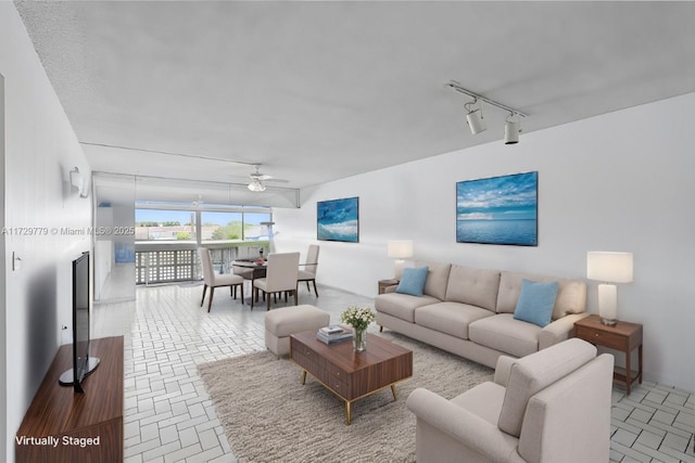 living room with track lighting and ceiling fan