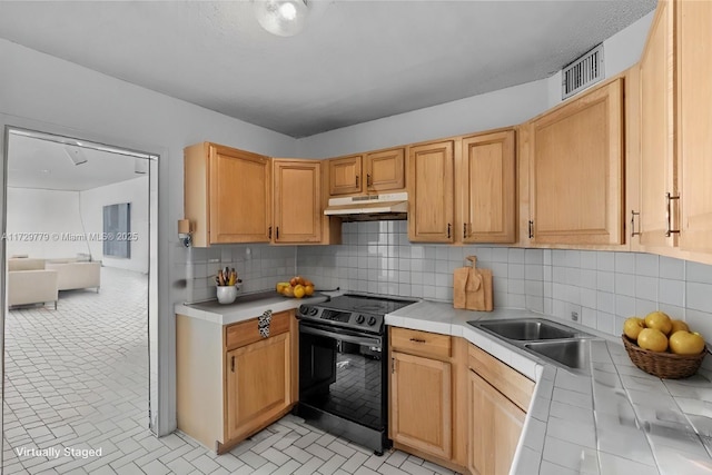 kitchen with light brown cabinetry, sink, tasteful backsplash, tile countertops, and electric range