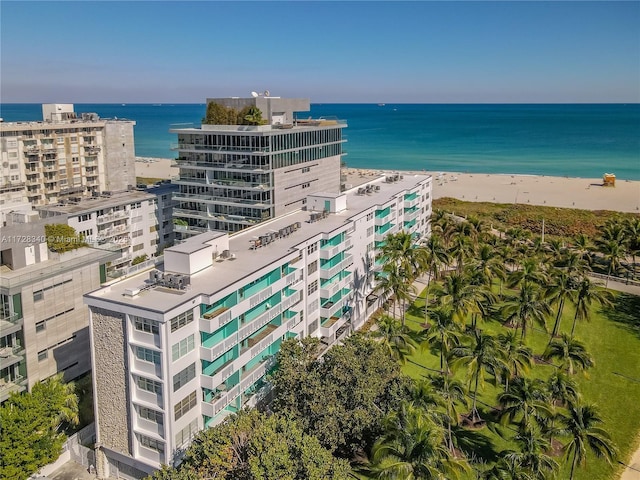 drone / aerial view featuring a water view and a beach view