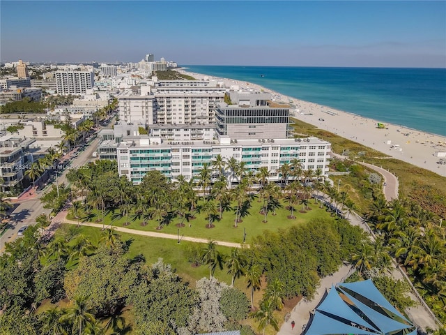 birds eye view of property with a water view and a view of the beach