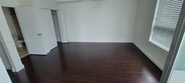 spare room featuring dark hardwood / wood-style flooring