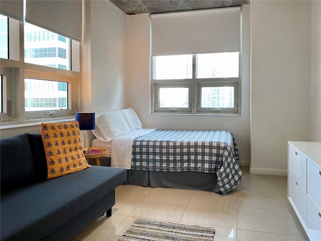 tiled bedroom with multiple windows