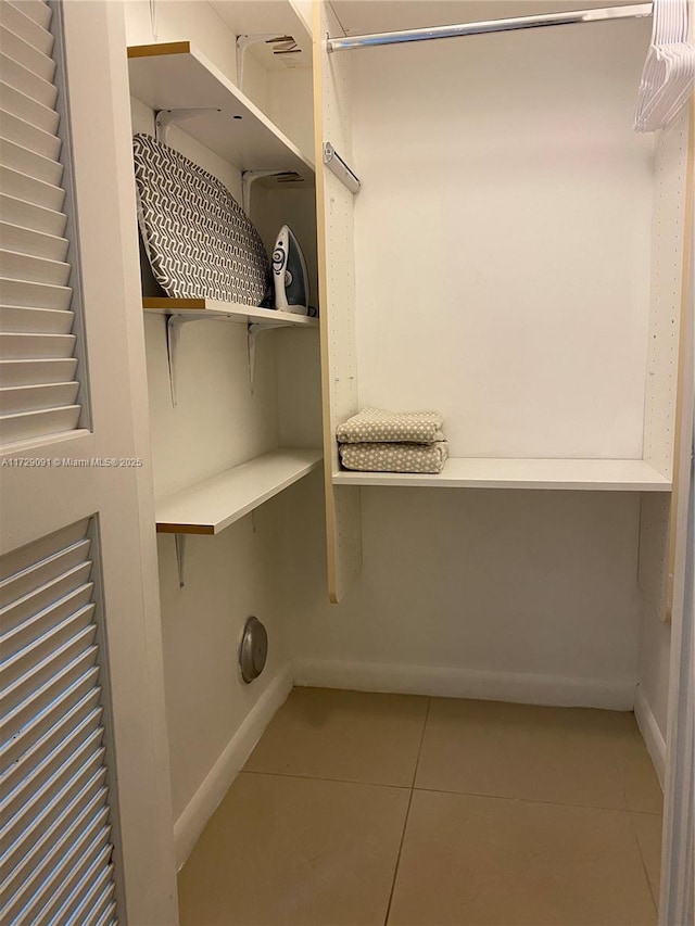 spacious closet with light tile patterned floors