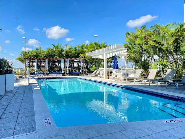 view of swimming pool featuring a patio and a pergola