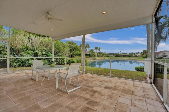 view of patio / terrace featuring ceiling fan and a water view