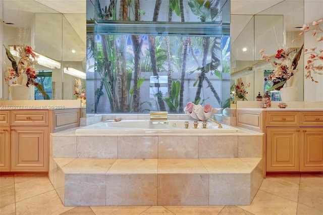 bathroom featuring vanity and tiled bath