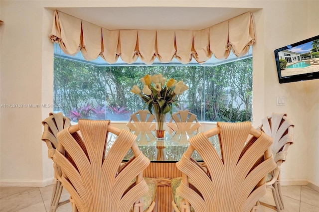 tiled dining space with a healthy amount of sunlight