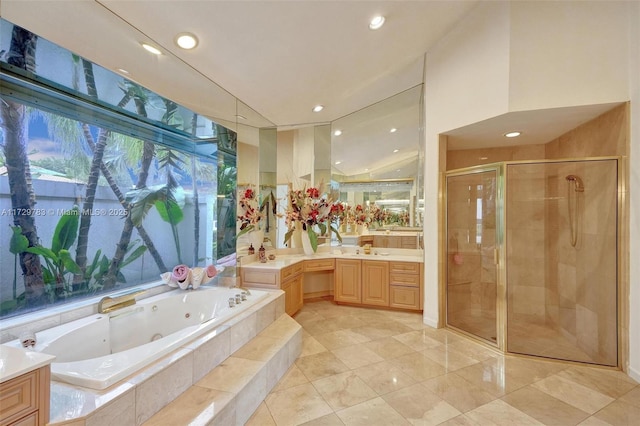 bathroom featuring vanity and independent shower and bath