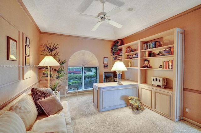 carpeted office space with crown molding, a textured ceiling, and ceiling fan