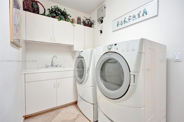 laundry room with sink, independent washer and dryer, cabinets, and light tile patterned floors