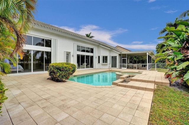 view of pool with an in ground hot tub and a patio