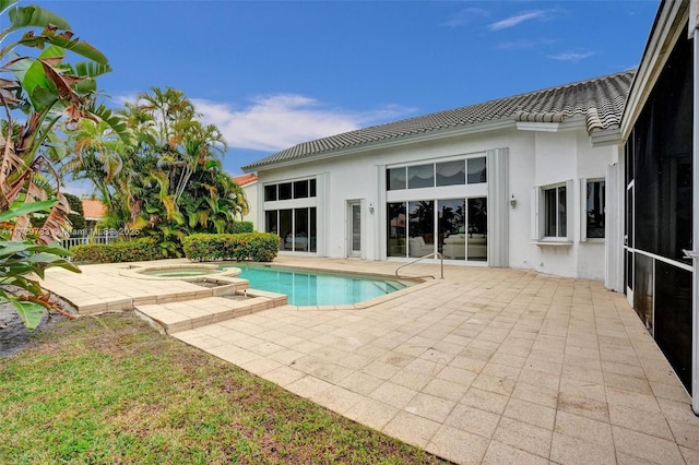 view of swimming pool featuring an in ground hot tub and a patio