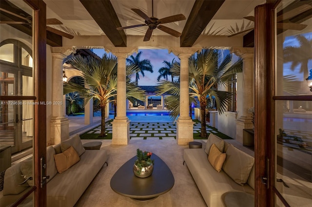 patio terrace at dusk with an outdoor hangout area, ceiling fan, and french doors