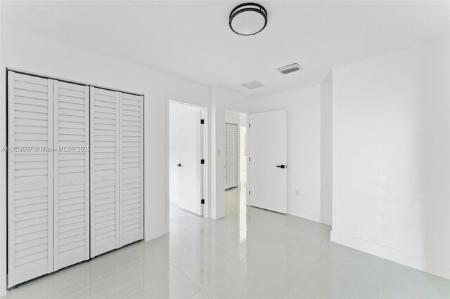 unfurnished bedroom with a closet