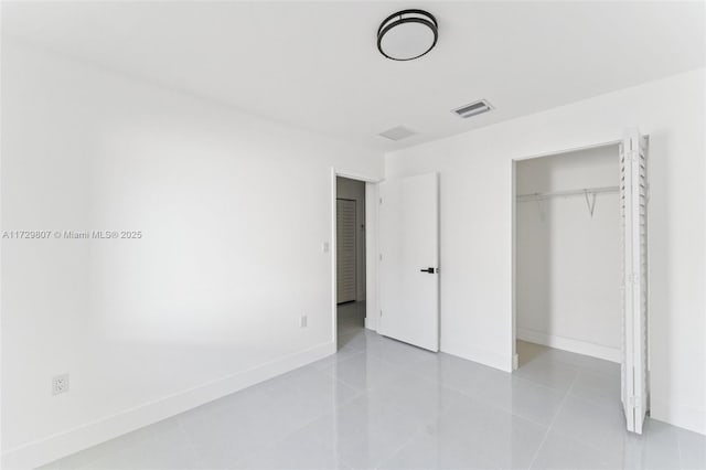 unfurnished bedroom with a closet and light tile patterned floors