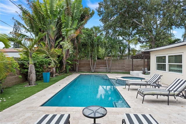 view of swimming pool with an in ground hot tub and a patio area