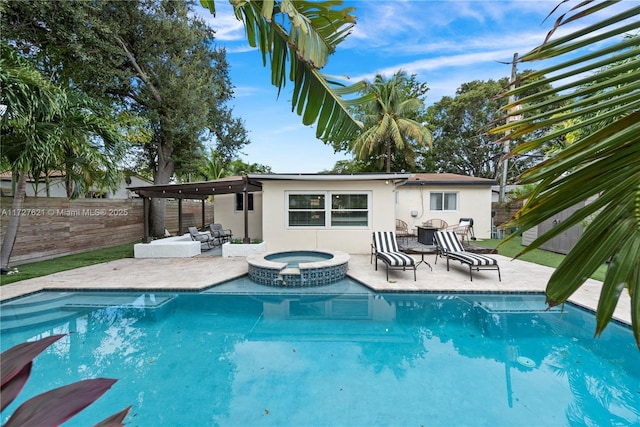 view of swimming pool with an in ground hot tub, outdoor lounge area, and a patio area