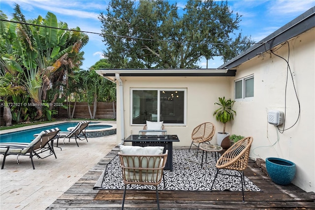 view of patio / terrace with a pool with hot tub