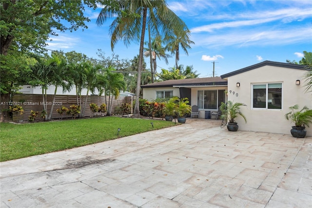 rear view of house featuring a yard