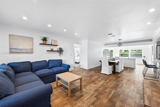 living room featuring crown molding and wood-type flooring