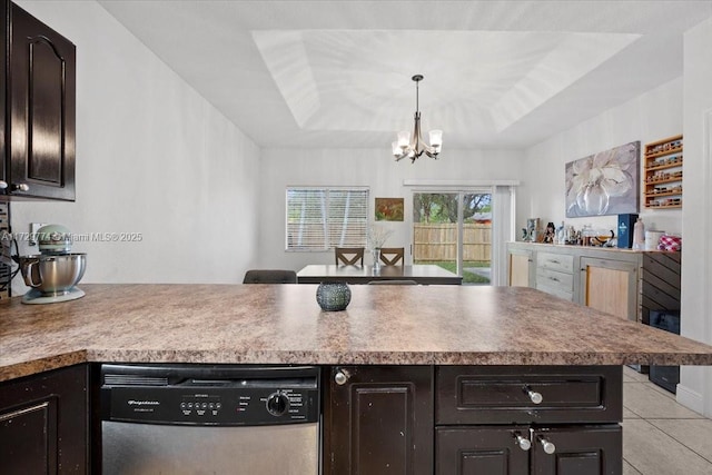 kitchen featuring hanging light fixtures, dark brown cabinetry, dishwasher, and a raised ceiling