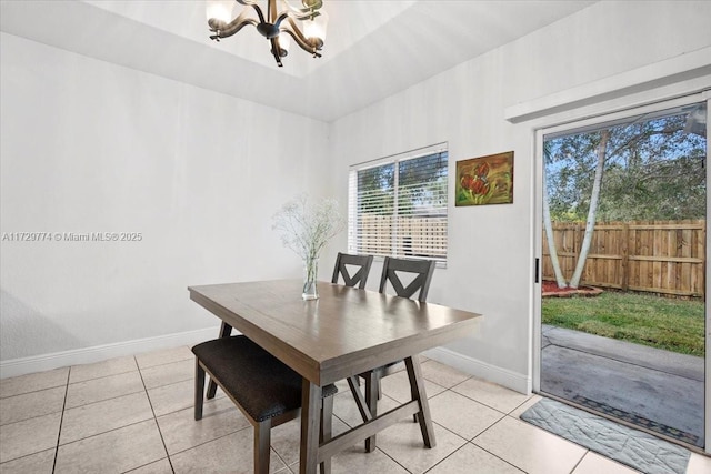 dining room featuring light tile patterned flooring and a chandelier