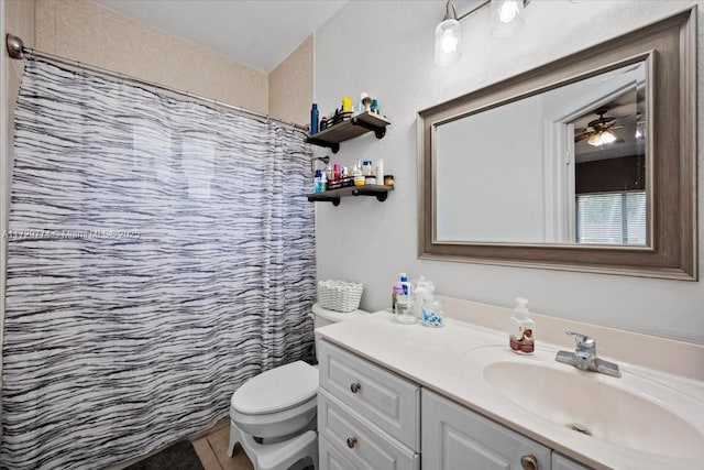 bathroom featuring vanity, toilet, curtained shower, and tile patterned flooring