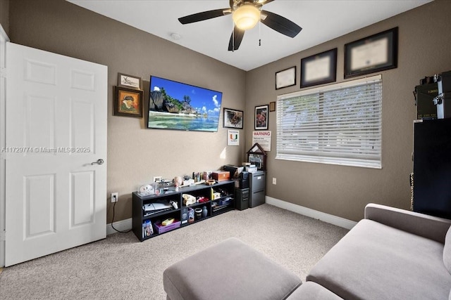 living area featuring ceiling fan and carpet