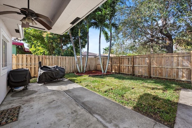 view of yard with ceiling fan and a patio area