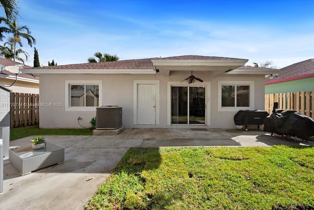 back of house featuring ceiling fan, a patio area, cooling unit, and a lawn