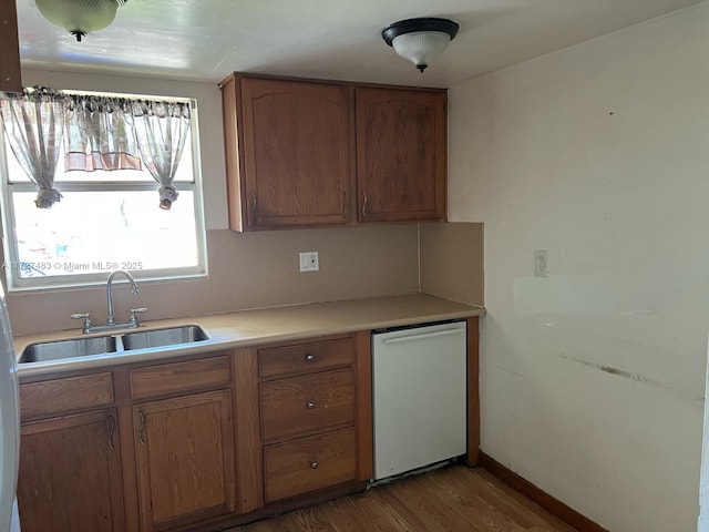 kitchen with sink and light hardwood / wood-style flooring