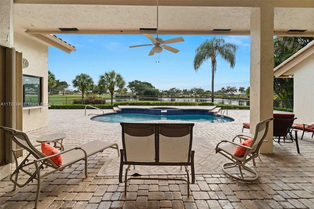 view of swimming pool featuring ceiling fan and a patio area