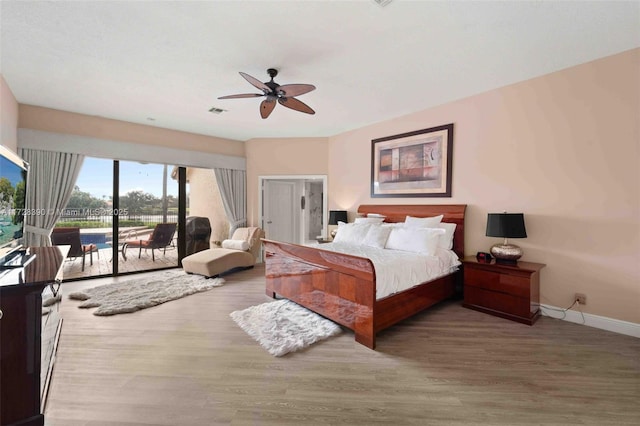 bedroom with ceiling fan, access to outside, and hardwood / wood-style flooring