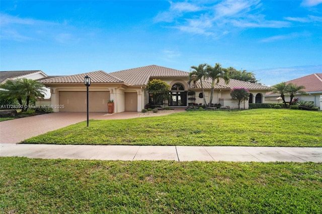 mediterranean / spanish-style home featuring a front yard and a garage