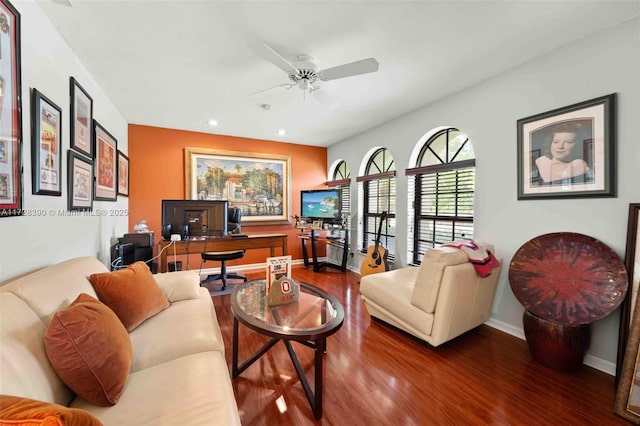 living room featuring ceiling fan and hardwood / wood-style floors