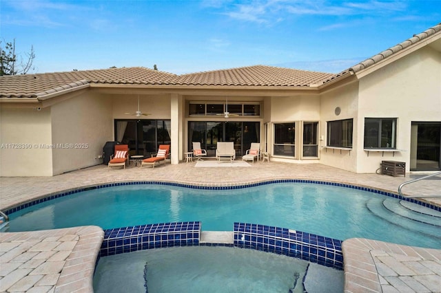 view of swimming pool with ceiling fan and a patio area