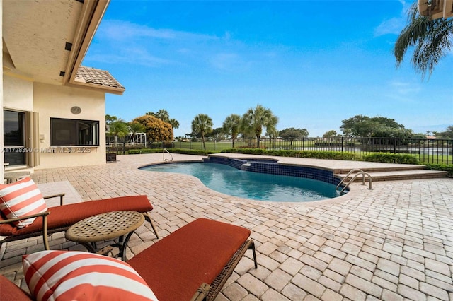 view of swimming pool featuring a patio area