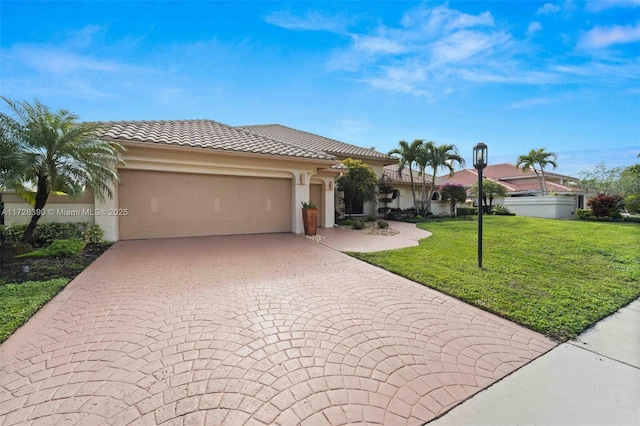 view of front of house with a garage and a front lawn