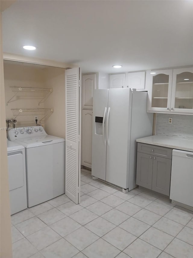 washroom featuring light tile patterned flooring and separate washer and dryer