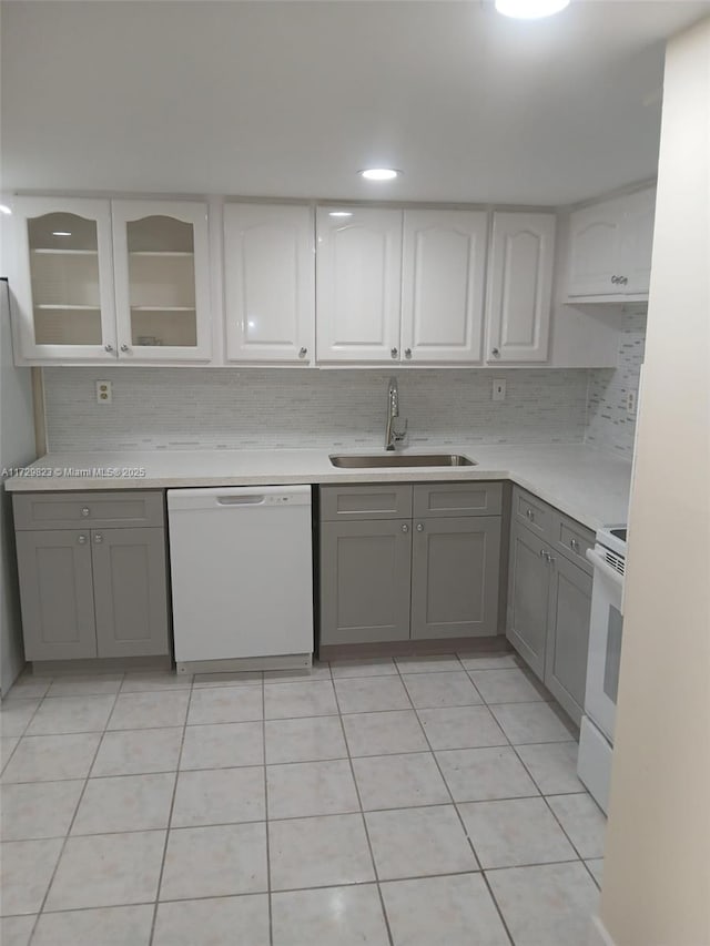 kitchen featuring white cabinetry, sink, gray cabinetry, and white appliances