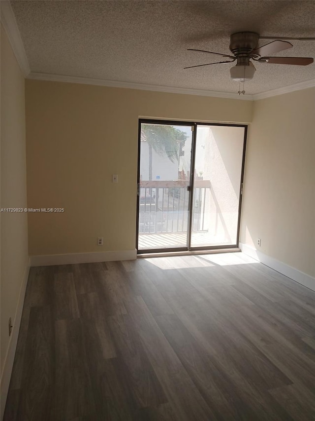 spare room featuring crown molding, dark wood-type flooring, and a textured ceiling