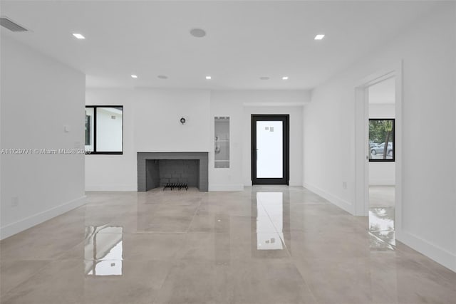 unfurnished living room with a brick fireplace