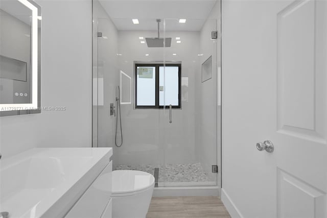 bathroom featuring vanity, toilet, and walk in shower