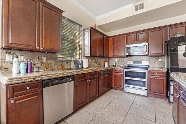 kitchen with sink, appliances with stainless steel finishes, light stone counters, tasteful backsplash, and ornamental molding