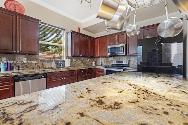 kitchen featuring sink, crown molding, backsplash, stainless steel appliances, and light stone counters