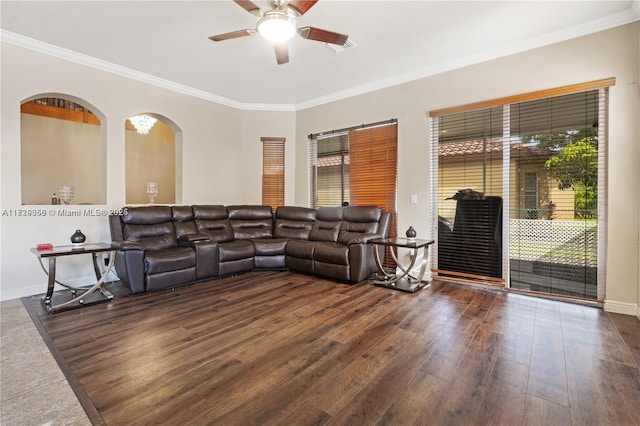 living room with dark hardwood / wood-style flooring, crown molding, and ceiling fan