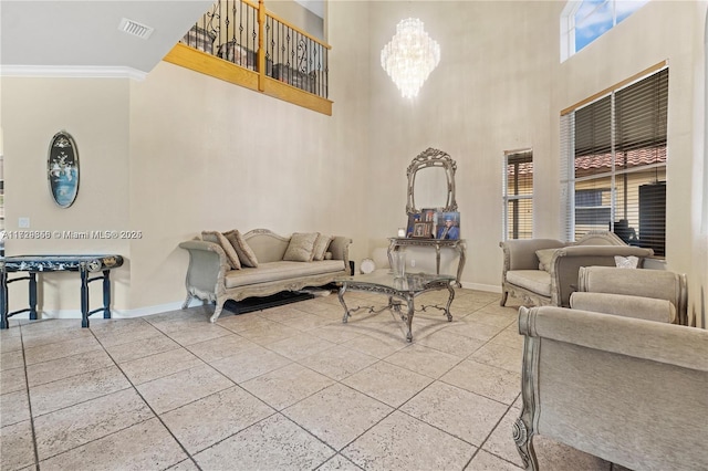 tiled living room with crown molding, a towering ceiling, and a notable chandelier