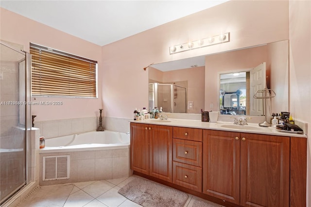 bathroom with tile patterned flooring, shower with separate bathtub, and vanity